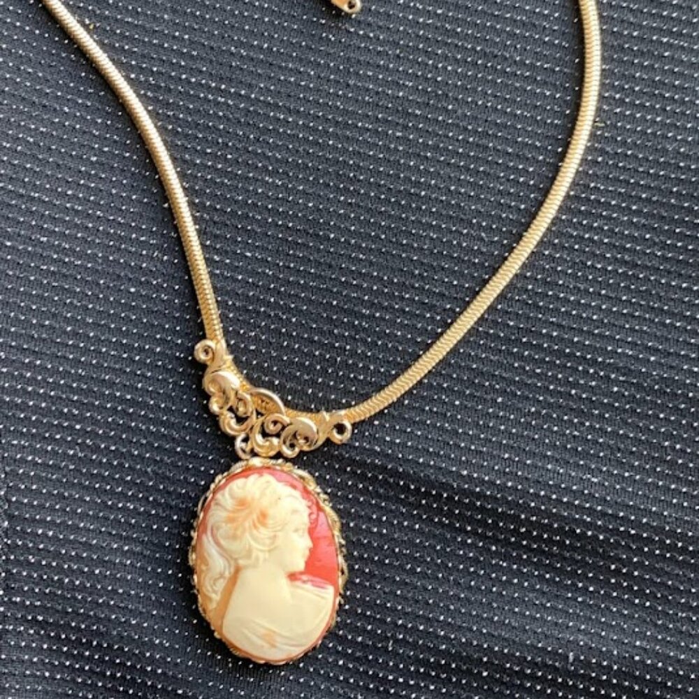 Gold Cameo Pendant Necklace with Coral Background